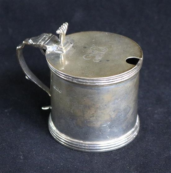 A 1920s silver drum shaped mustard pot with plated ladle.